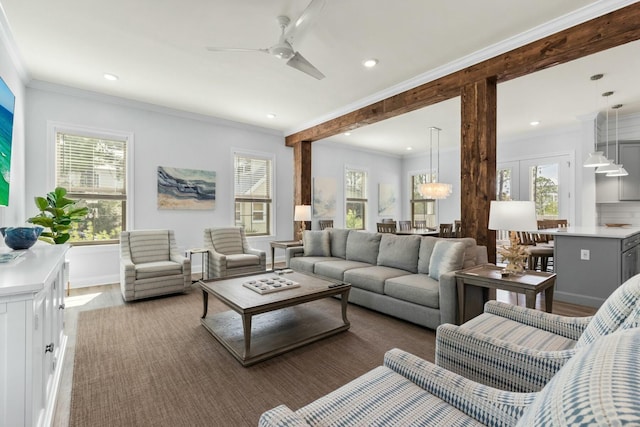 living area with recessed lighting, ceiling fan with notable chandelier, crown molding, and wood finished floors