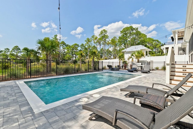 view of pool featuring a patio area, a fenced in pool, and fence