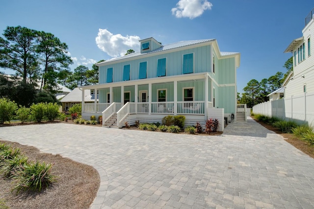 view of front of property featuring covered porch, board and batten siding, and metal roof