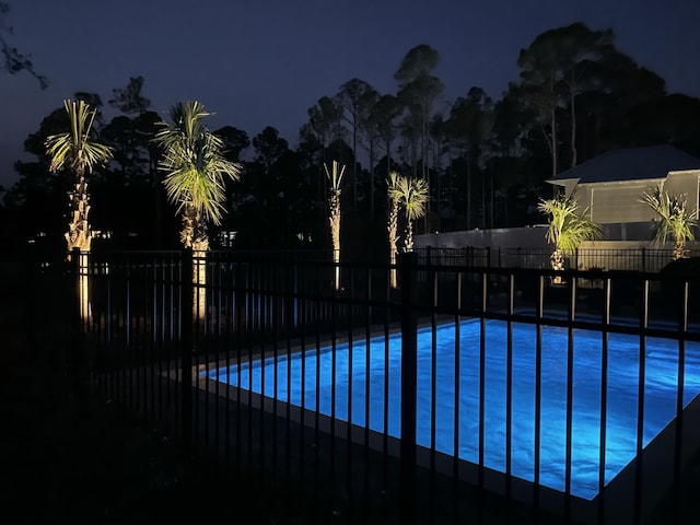 pool at twilight featuring fence