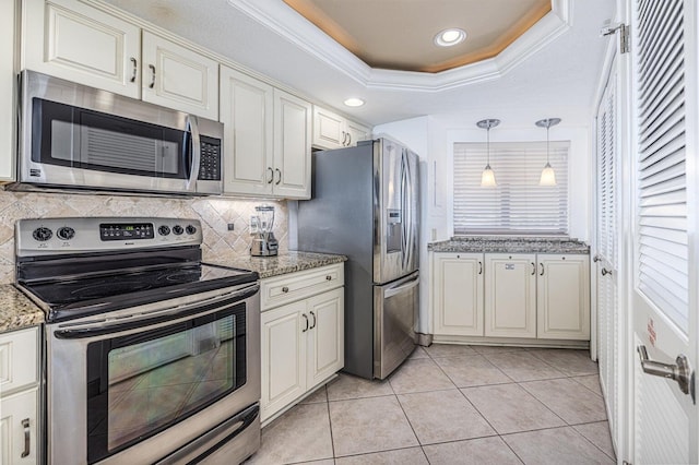 kitchen with tasteful backsplash, crown molding, light tile patterned floors, stainless steel appliances, and a raised ceiling