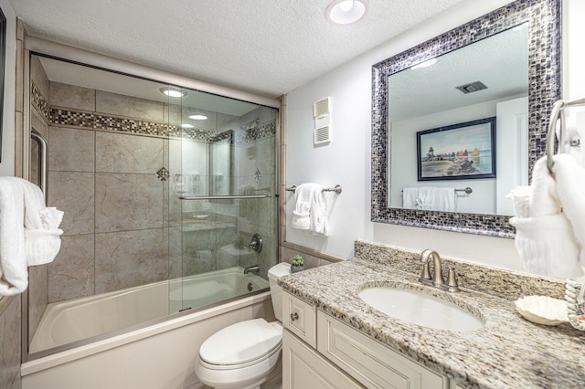 full bathroom with visible vents, toilet, shower / bath combination with glass door, and a textured ceiling