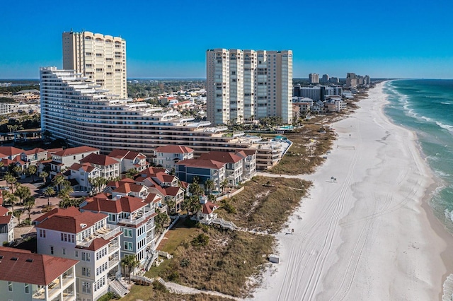 drone / aerial view featuring a city view, a beach view, and a water view