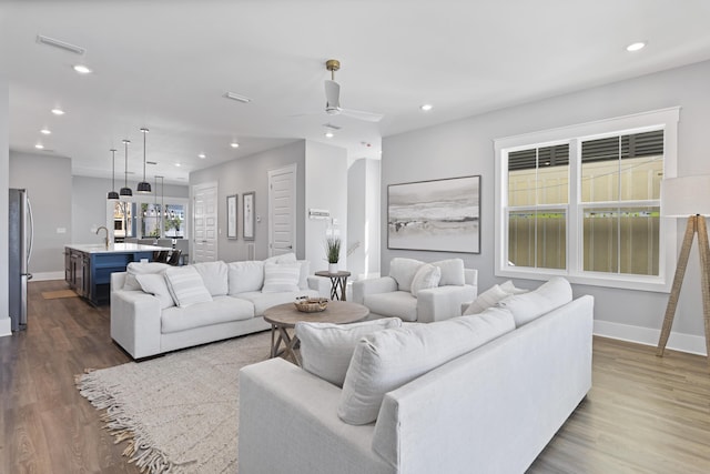 living area featuring dark wood-style floors, recessed lighting, a ceiling fan, and visible vents