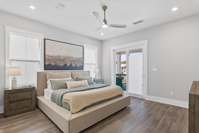 bedroom with access to outside, wood finished floors, visible vents, and baseboards