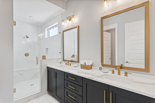 full bathroom featuring double vanity, a marble finish shower, and a sink