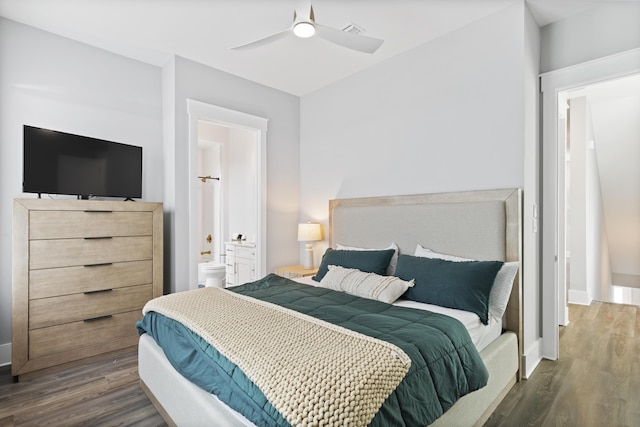 bedroom featuring a ceiling fan, wood finished floors, baseboards, and ensuite bathroom