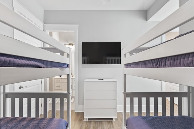 bedroom with baseboards and wood finished floors