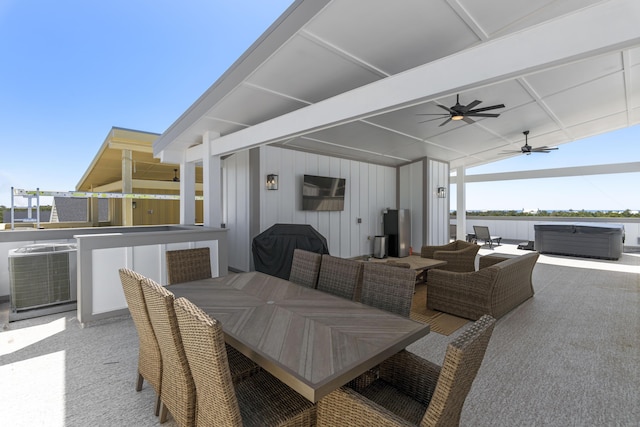 view of patio / terrace featuring a ceiling fan, central AC unit, area for grilling, outdoor dining area, and a hot tub