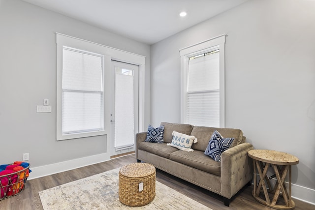 living area with recessed lighting, wood finished floors, and baseboards