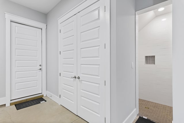 foyer entrance with recessed lighting and baseboards