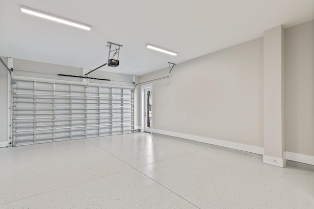 garage featuring baseboards and a garage door opener