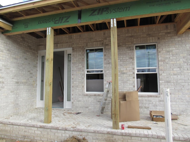 view of exterior entry with brick siding