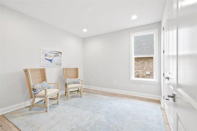 sitting room with recessed lighting, light wood-type flooring, and baseboards