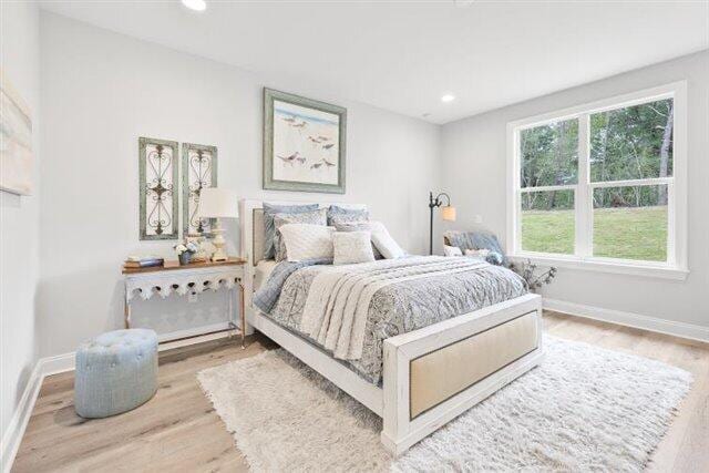 bedroom featuring recessed lighting, wood finished floors, and baseboards