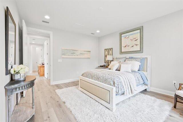 bedroom with recessed lighting, visible vents, light wood-style flooring, and baseboards