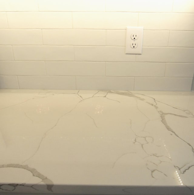 bathroom featuring concrete block wall