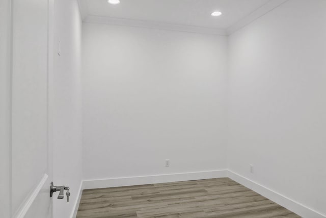 unfurnished room featuring ornamental molding, baseboards, and wood finished floors