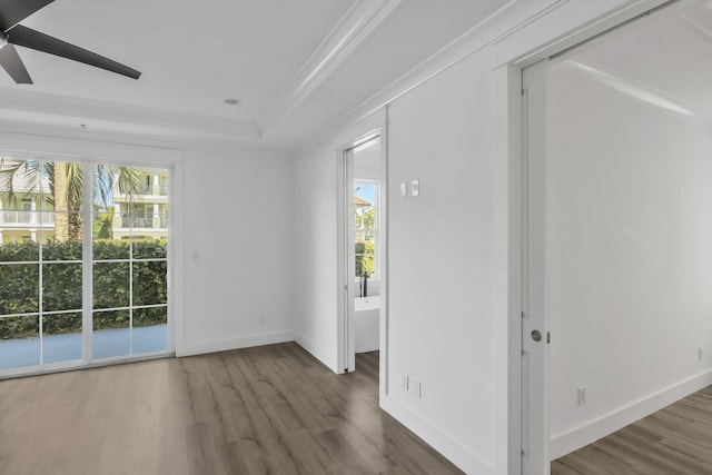 spare room with ceiling fan, baseboards, a healthy amount of sunlight, and wood finished floors