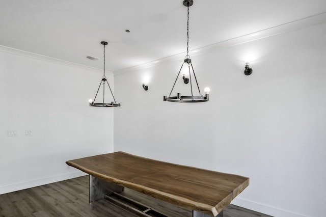 unfurnished dining area featuring visible vents, baseboards, dark wood-style flooring, and crown molding