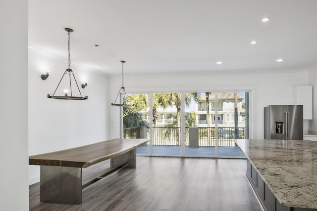 kitchen with crown molding, wood finished floors, and high end fridge