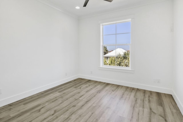 spare room featuring a ceiling fan, wood finished floors, baseboards, recessed lighting, and ornamental molding