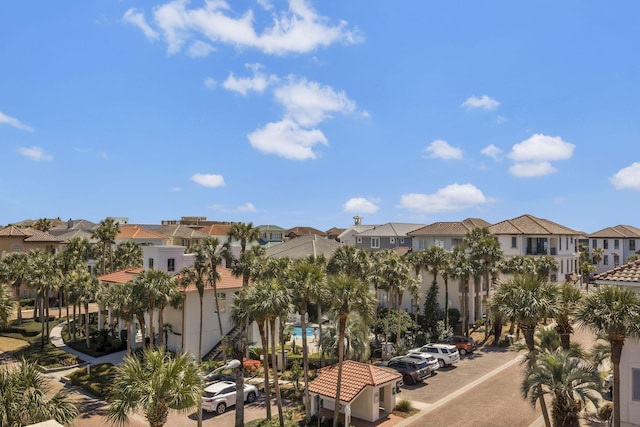 view of building exterior featuring a residential view and uncovered parking