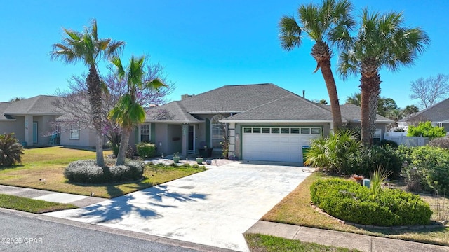 ranch-style house with stucco siding, an attached garage, concrete driveway, and a front yard