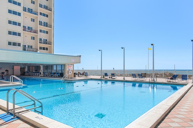 pool featuring a patio area and fence