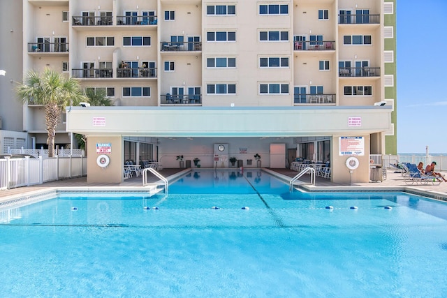 view of swimming pool featuring a patio area and fence