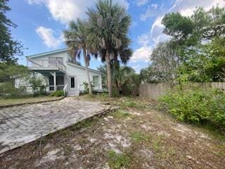 view of yard with a balcony and a fenced backyard