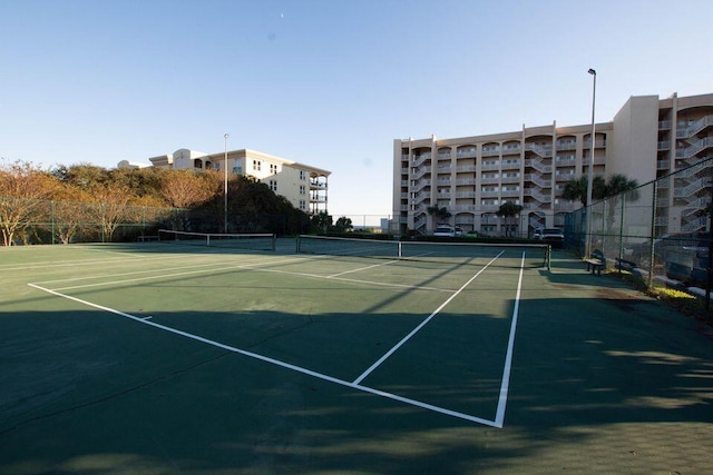 view of tennis court with fence