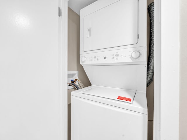 laundry area with stacked washer / dryer and laundry area