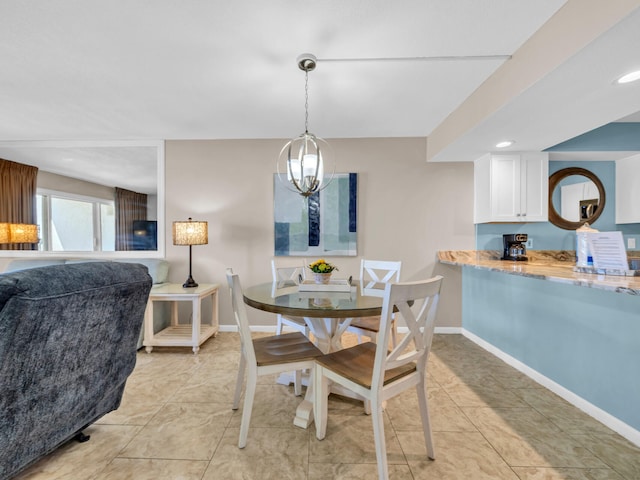 dining room featuring a chandelier, light tile patterned flooring, and baseboards