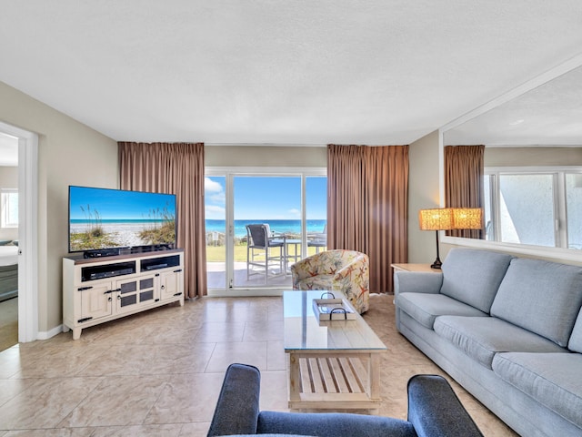 living area featuring a healthy amount of sunlight and light tile patterned floors