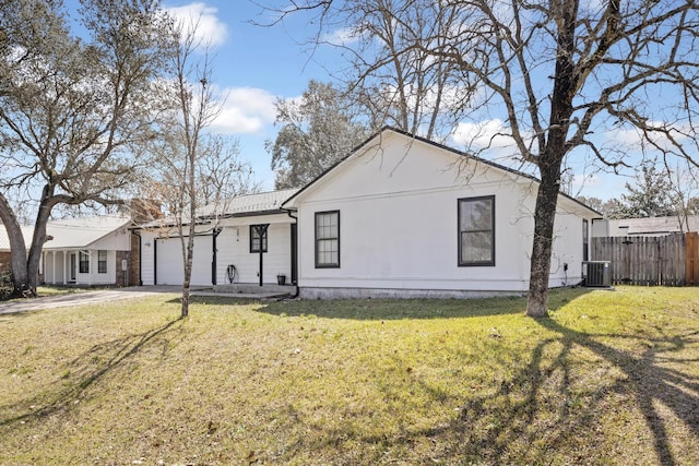 single story home featuring a front yard, fence, driveway, a garage, and central air condition unit