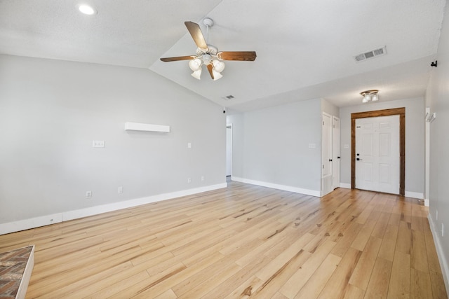 unfurnished room with vaulted ceiling, baseboards, visible vents, and light wood finished floors