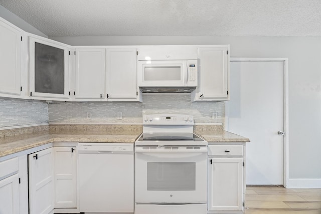 kitchen featuring light wood-type flooring, white appliances, white cabinetry, and light countertops