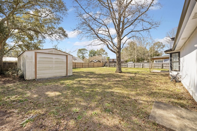 view of yard featuring an outdoor structure, a fenced backyard, and a shed