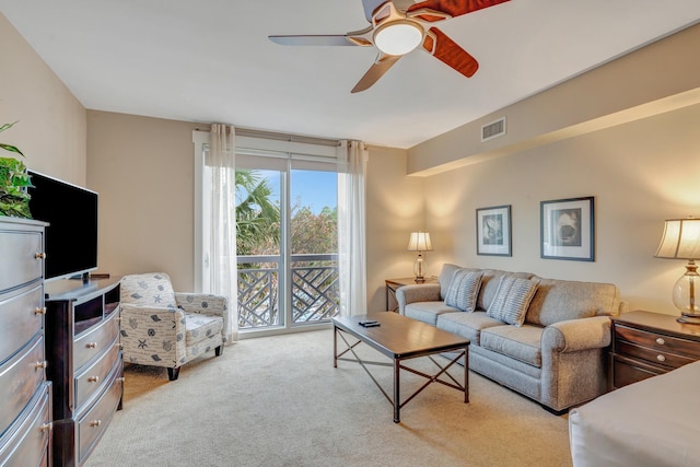 carpeted living room featuring visible vents and a ceiling fan