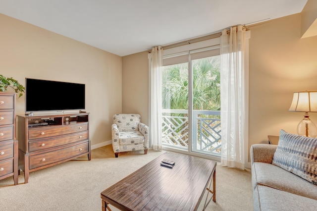 carpeted living room with baseboards