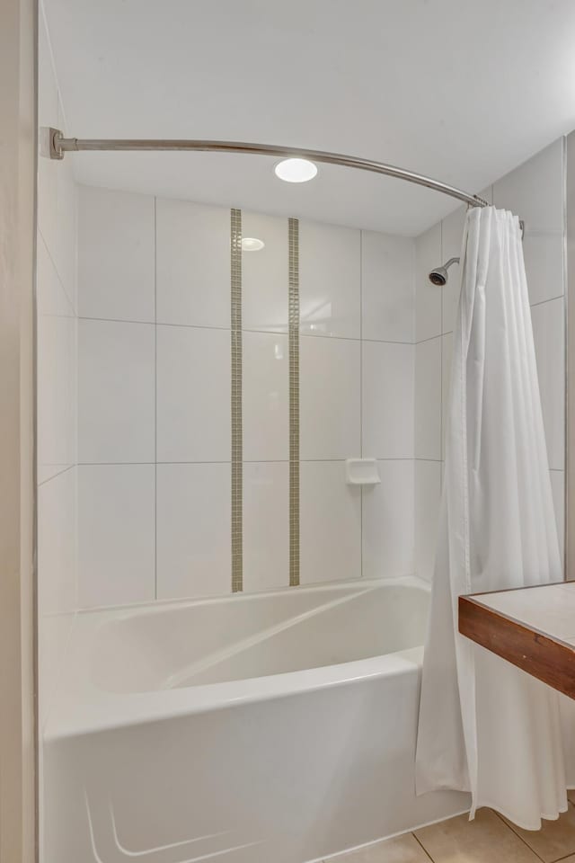 bathroom featuring tile patterned flooring and shower / bath combo