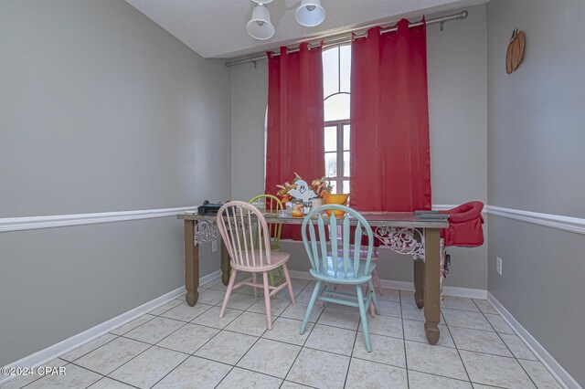 dining room featuring tile patterned floors and baseboards