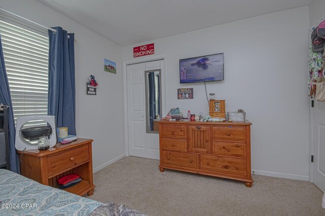 bedroom featuring baseboards and carpet