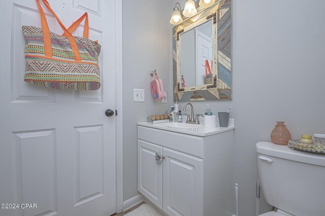 bathroom featuring vanity and toilet