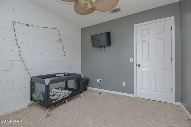 sitting room featuring a ceiling fan, carpet, visible vents, and baseboards