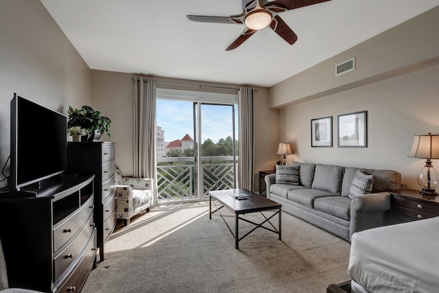 living room featuring visible vents, ceiling fan, and carpet flooring