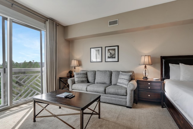 living room featuring visible vents and light carpet