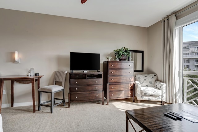 living area featuring baseboards and carpet floors