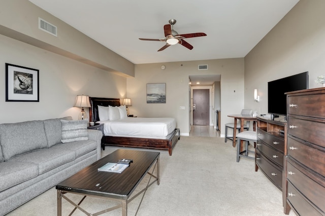 bedroom with light carpet, visible vents, and baseboards